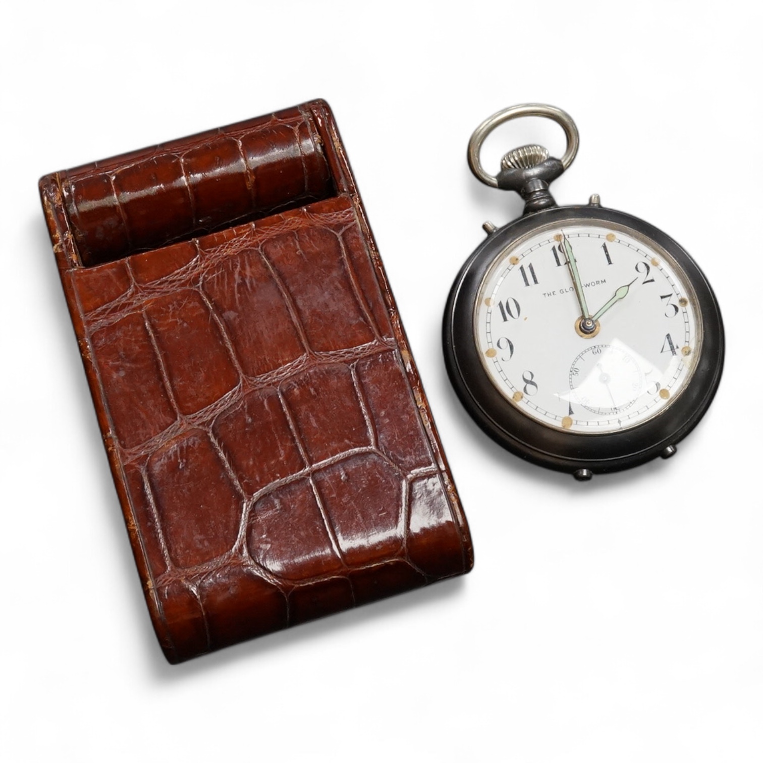 A Finnegan's leather cased travelling timepiece and a base metal Glow Worm pocket watch.